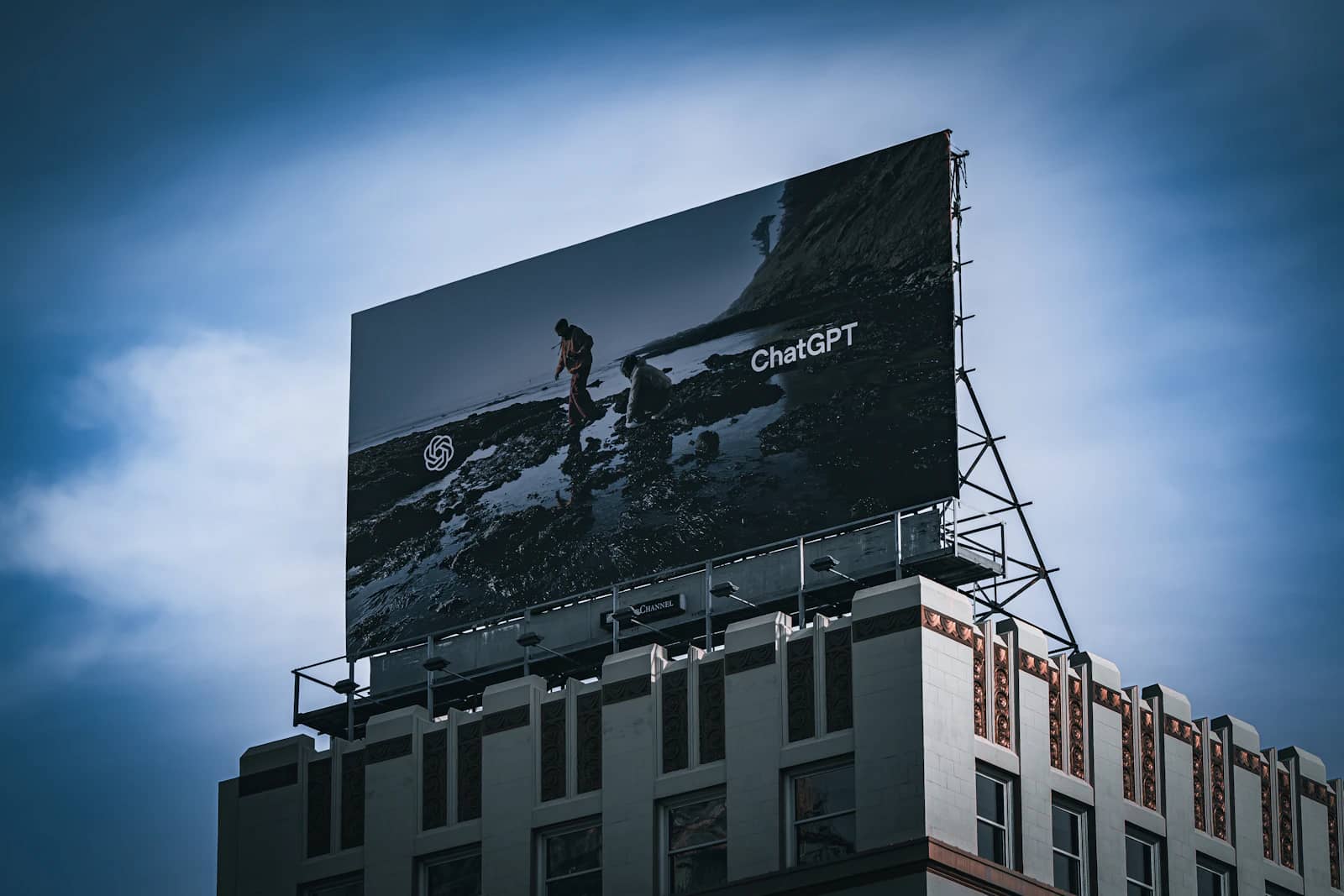Rooftop billboard against a blue sky